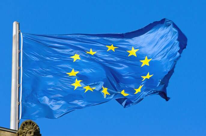 European Union flag on blue sky.